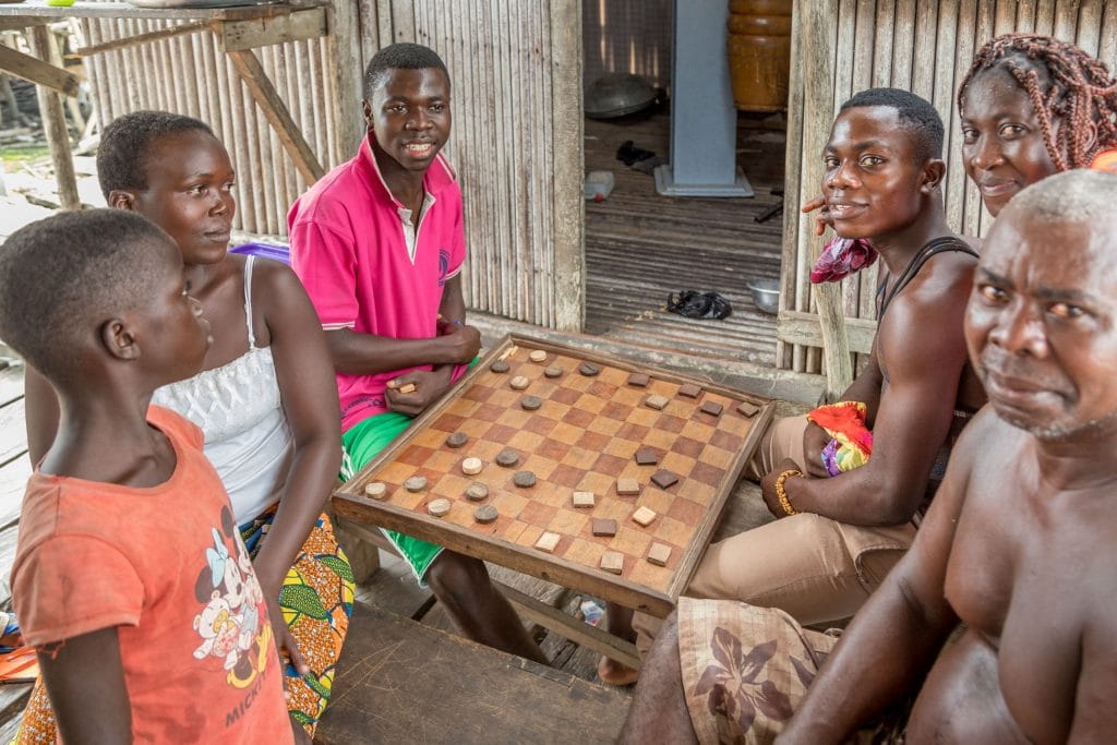 Village people playing a game - GHANA - Stilt village Nzulezo on lake Tadane (Beyin); day trip from Takoradi